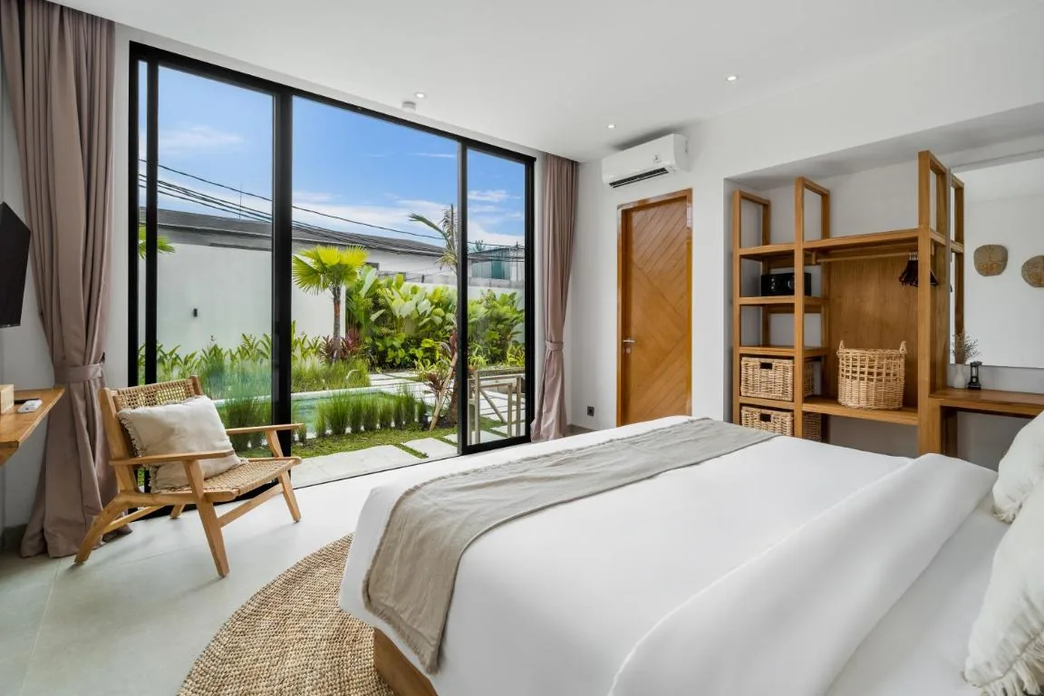 Villa Bahagia bedroom with garden view, wood wardrobe and air conditioning