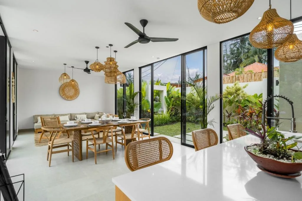 Villa Bahagia dining table and kitchen with garden view and rattan lighting