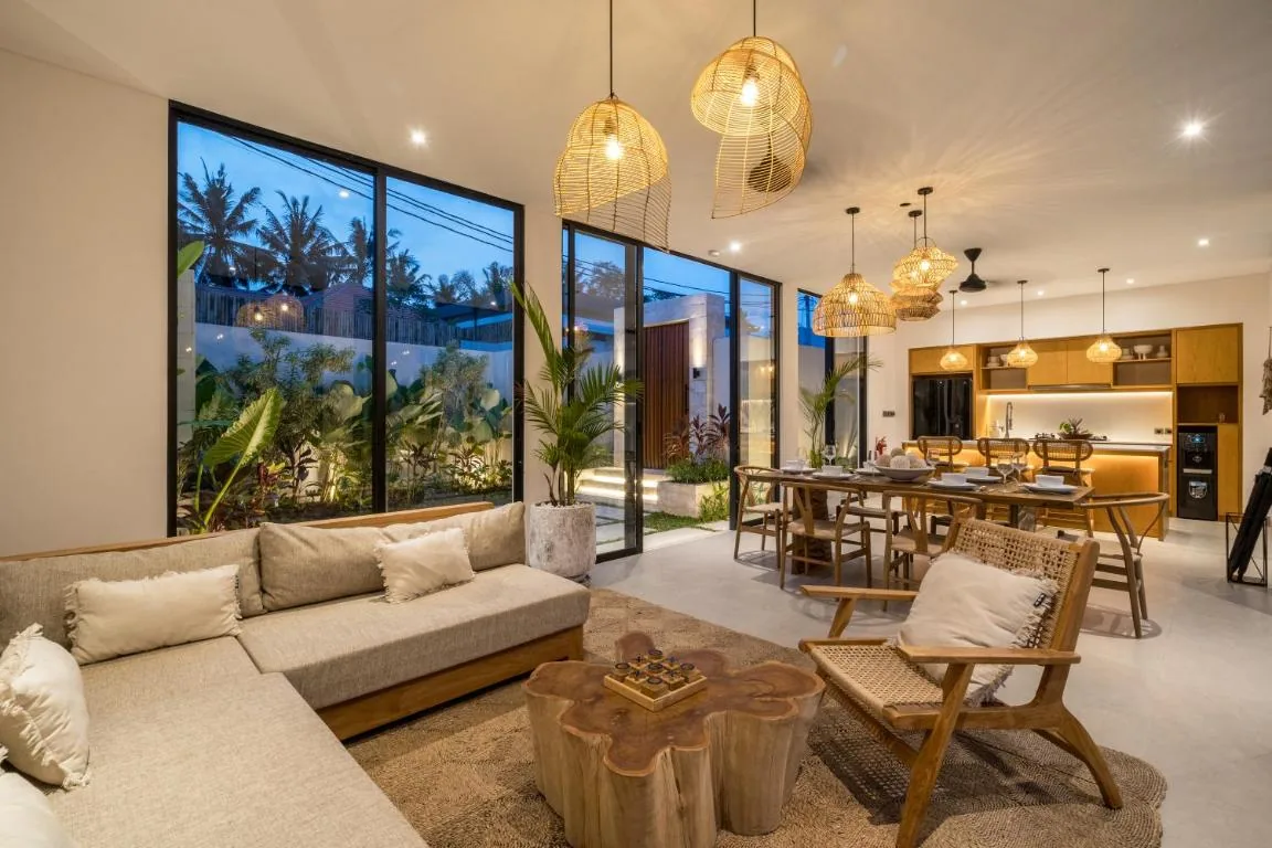 Villa Bahagia living room at night with warm rattan pendant lights