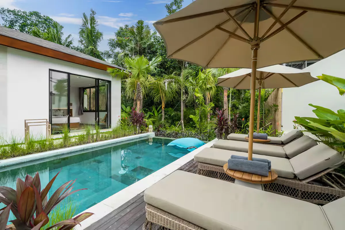 Private swimming pool at Villa Bahagia with loungers and tropical garden
